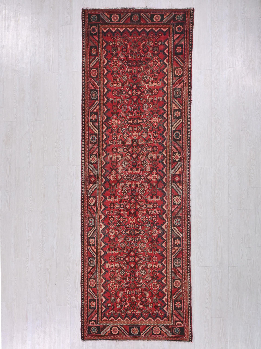 a red rug hanging up against a wall
