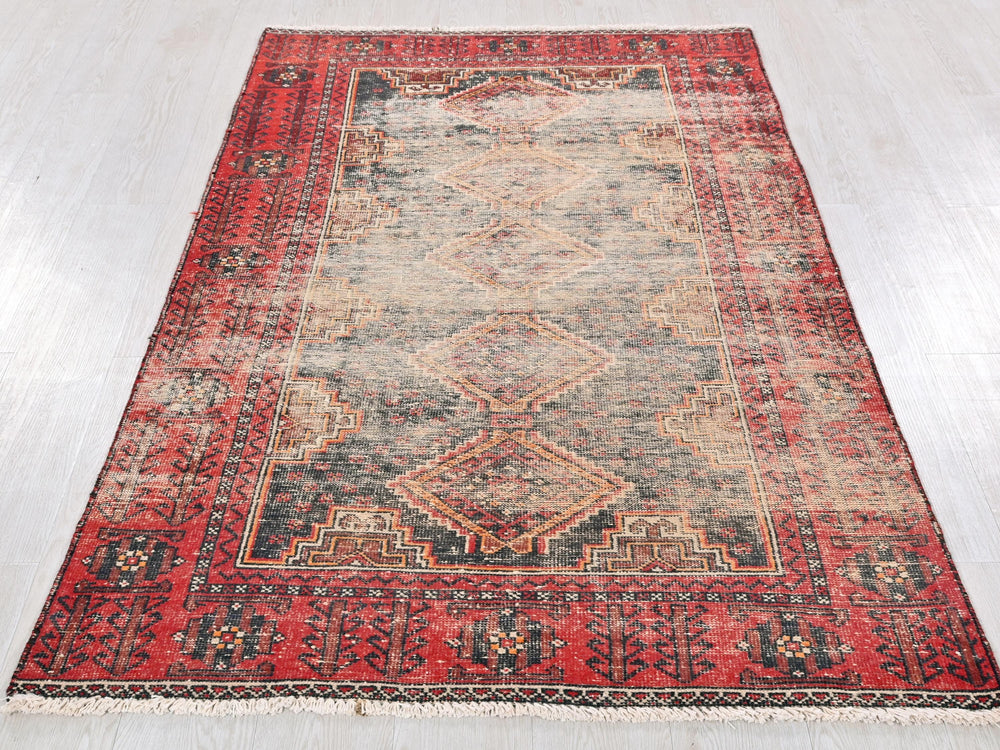 a red rug with a diamond pattern on it