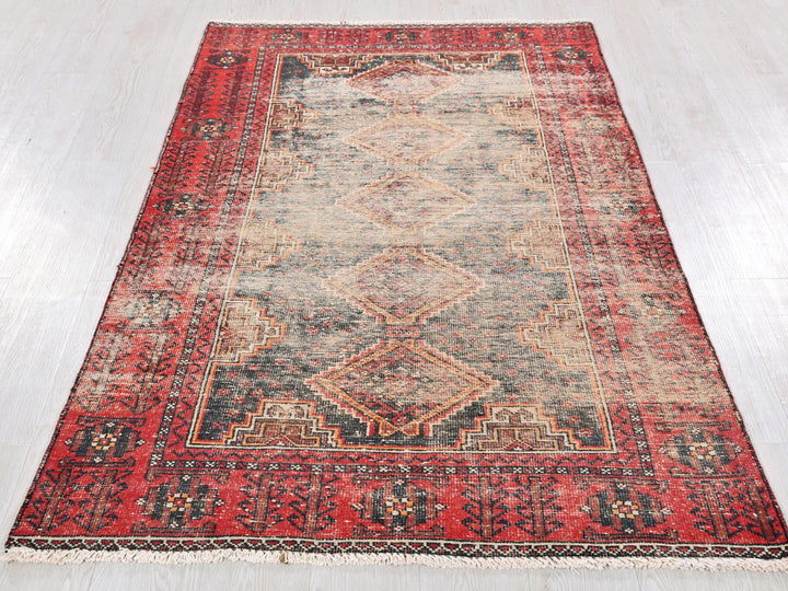 a red rug with a diamond pattern on it