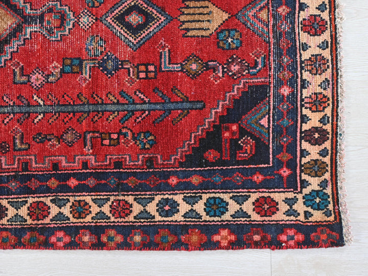 a red rug with a blue border on a white background