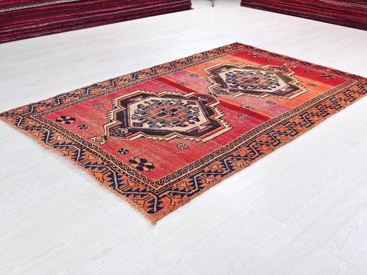 a red rug on the floor of a room