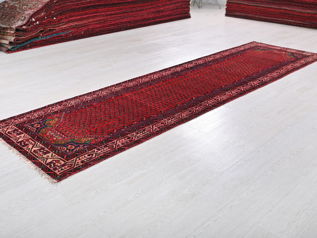 a red rug is laying on a white floor