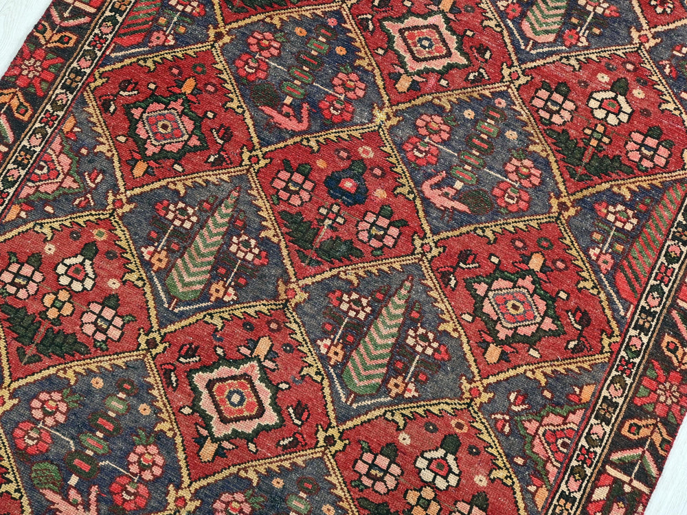 a red rug with a diamond pattern on it