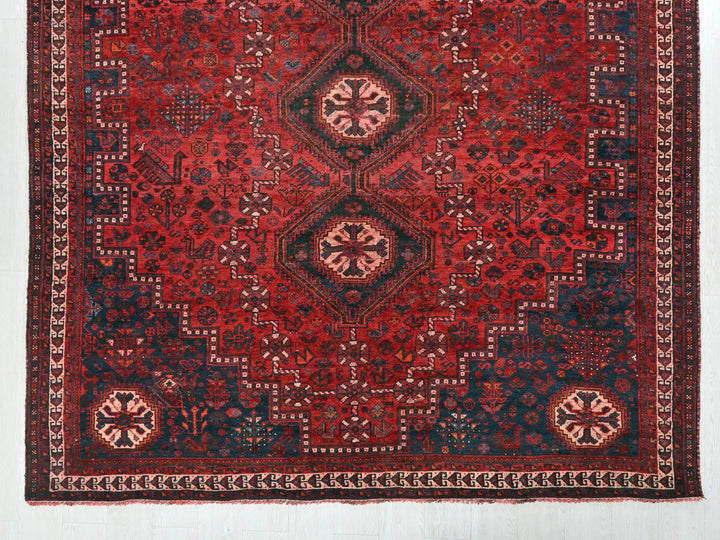 a red and blue rug with a design on it