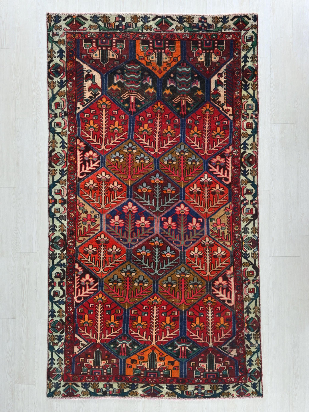 a red rug with a design on the middle of it