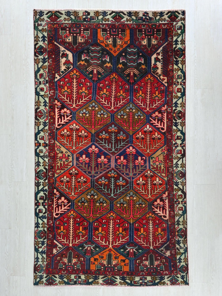 a red rug with a design on the middle of it
