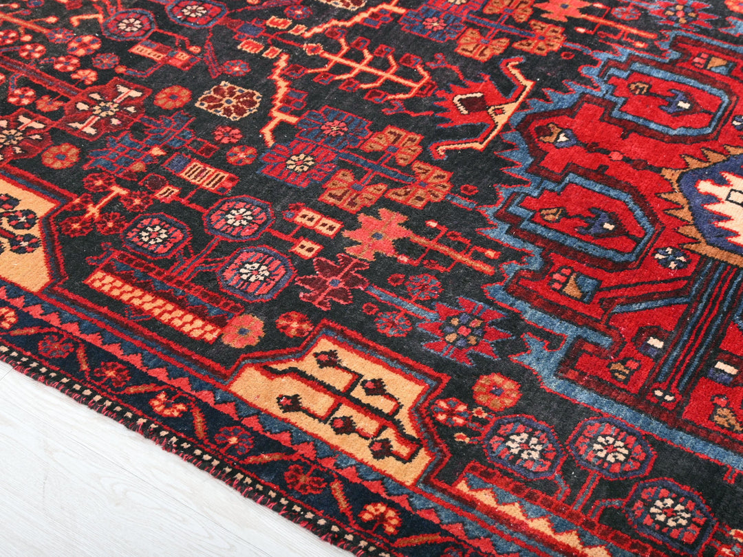 a red and blue rug on a white floor