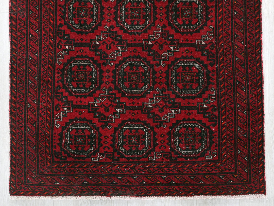 a red rug with black and white designs on it