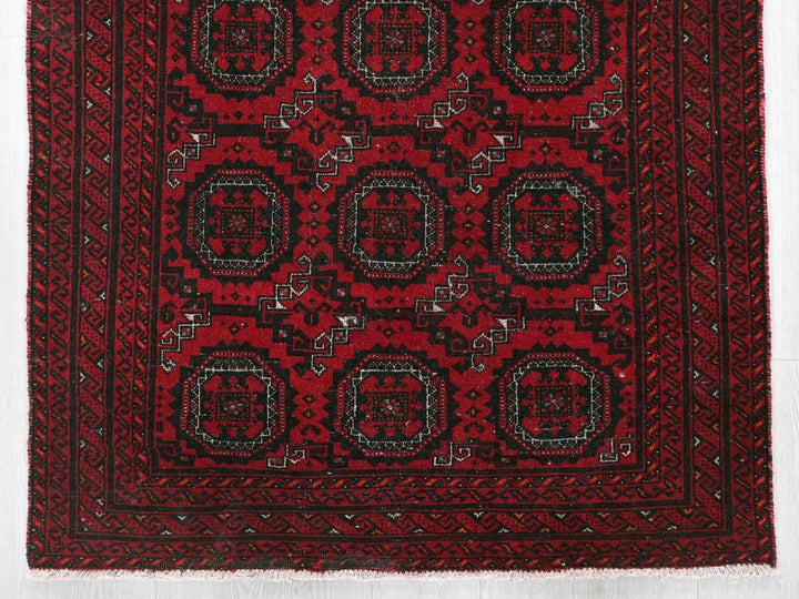 a red rug with black and white designs on it