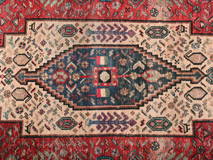 a red rug with a blue, white, and red design