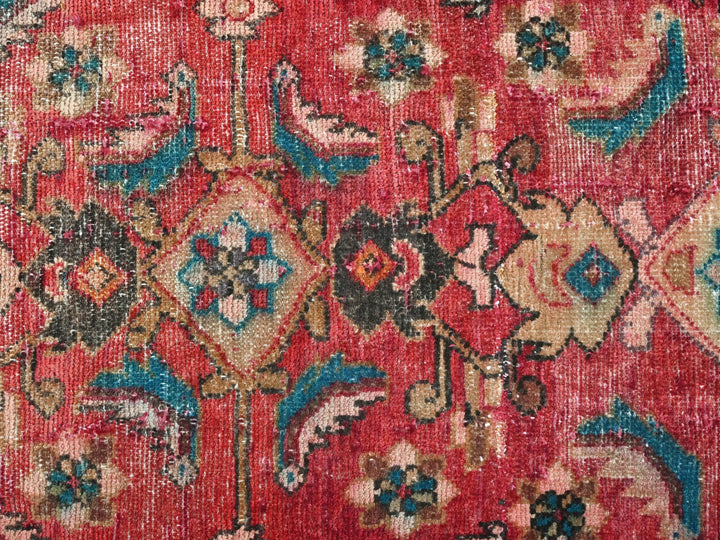 a close up of a rug with a red background