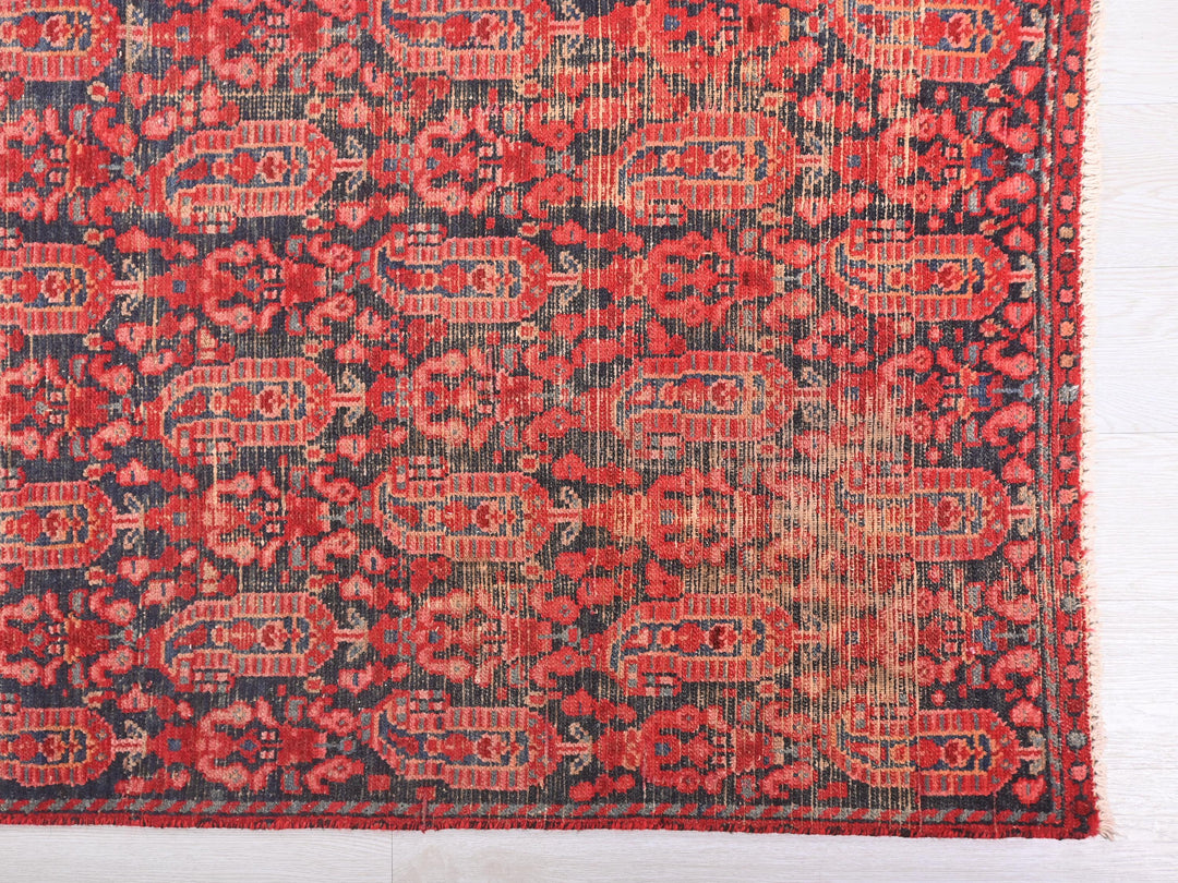 a red and black rug with a design on it