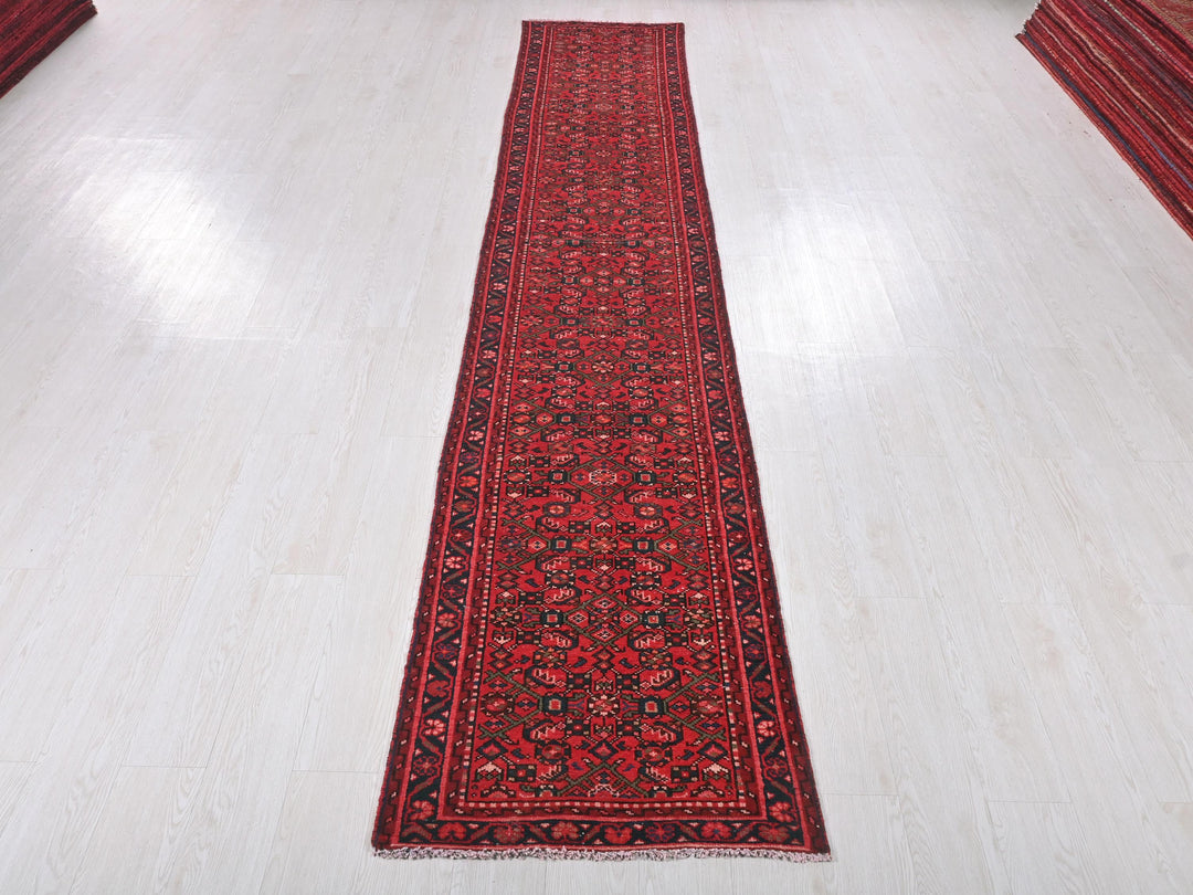 a long red rug on a white floor
