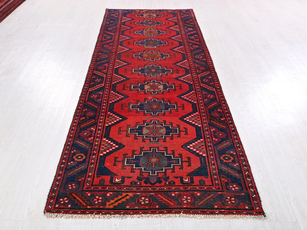 a red rug on a white floor in a room