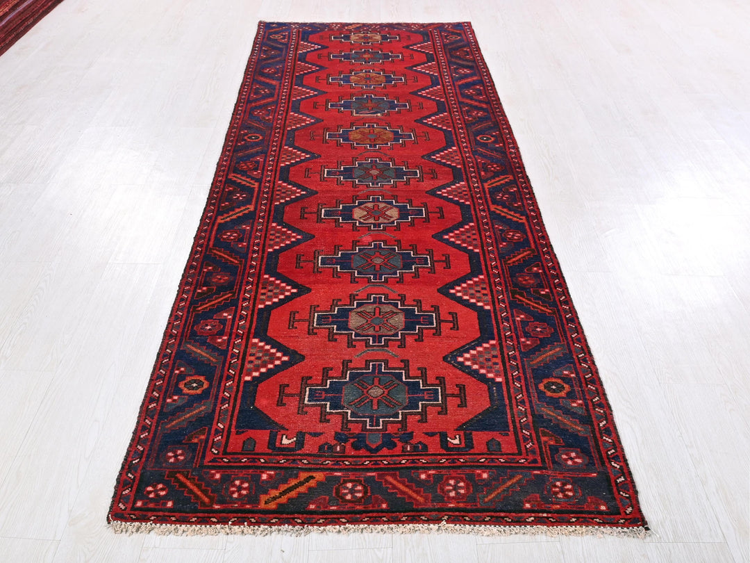 a red rug on a white floor in a room