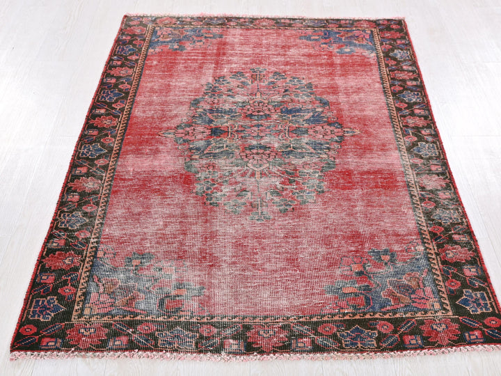 a red rug with a medallion design on it