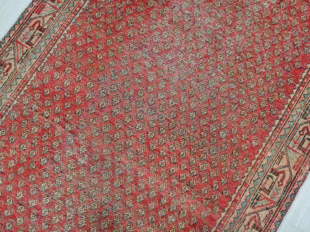 a red rug on a white wooden floor