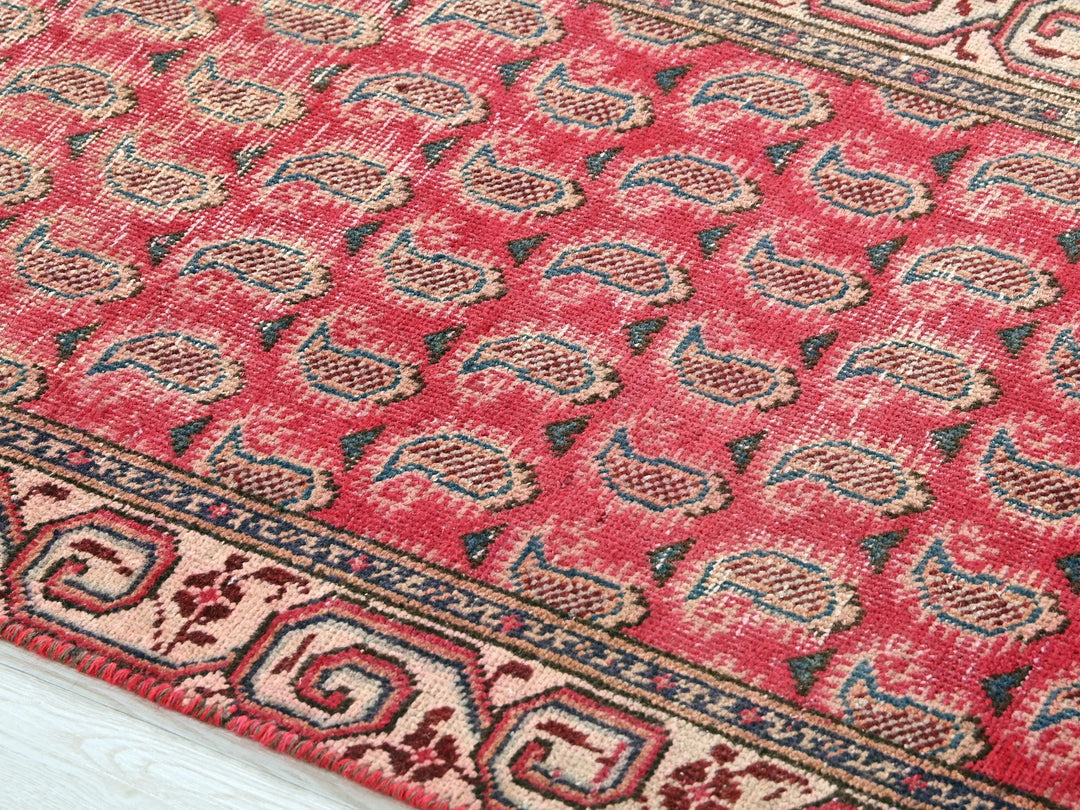 a red and blue rug on a white floor