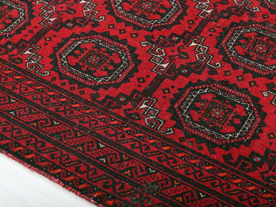a close up of a red and black rug