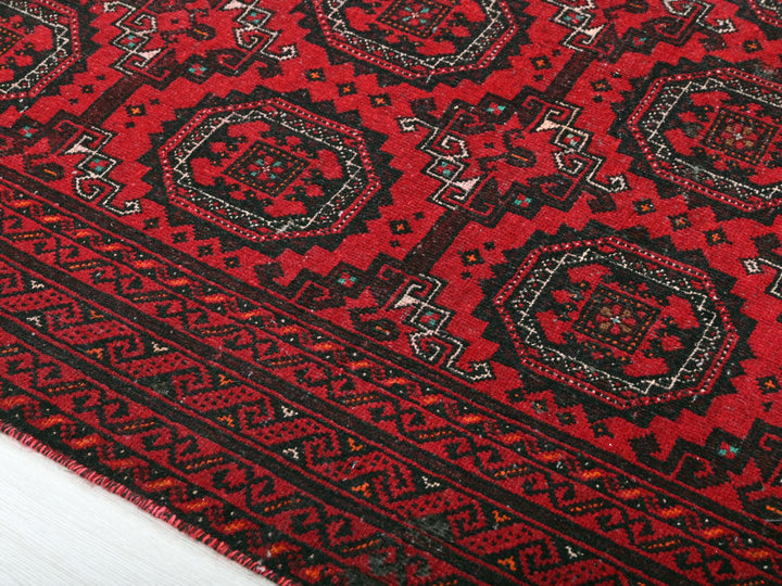 a close up of a red and black rug