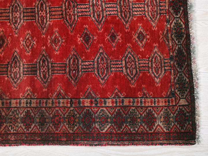 a red and black rug with a pattern on it