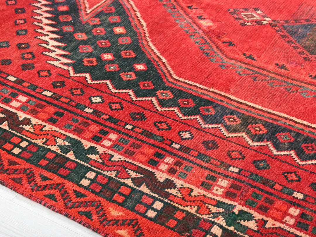 a close up of a red rug on the floor