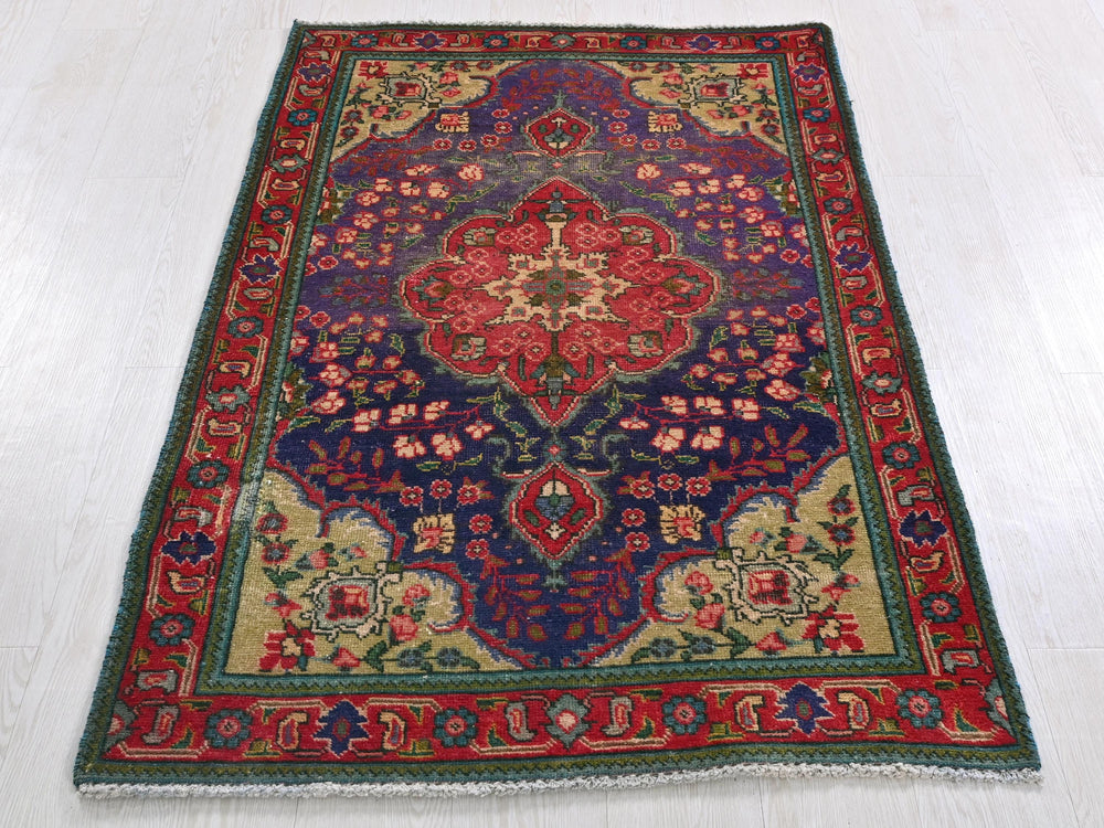a colorful rug on a white floor in a room
