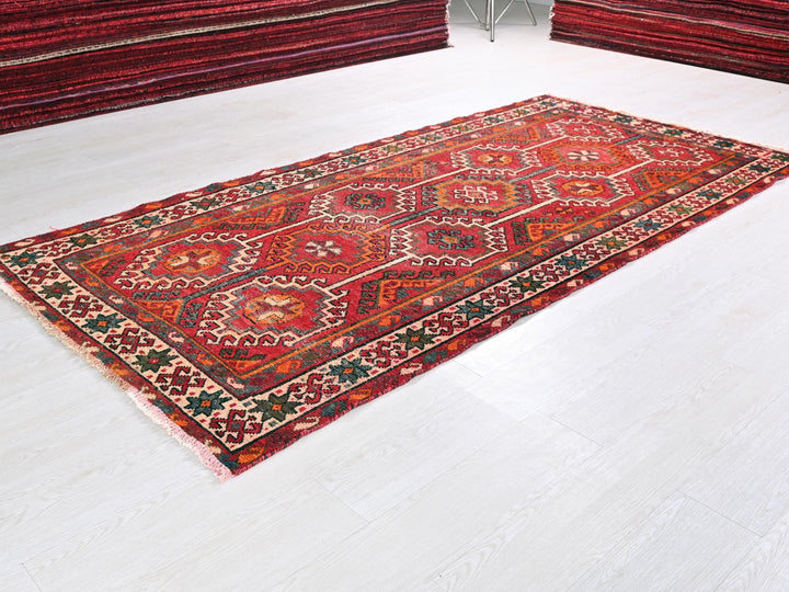 a red rug on a white floor in a room