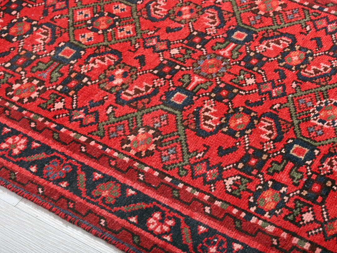 a close up of a red rug on the floor