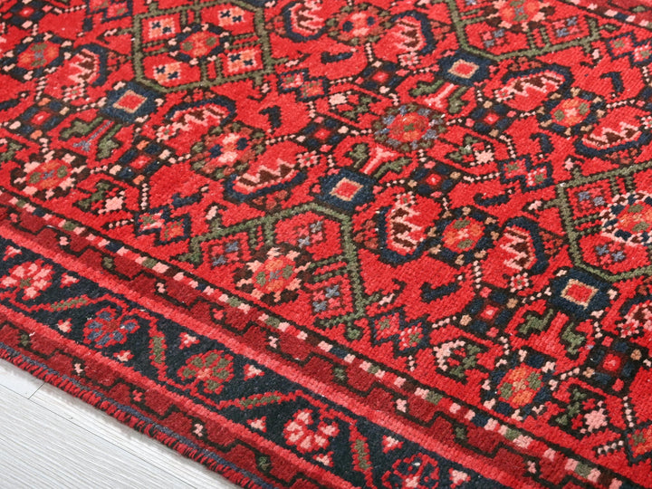 a close up of a red rug on the floor
