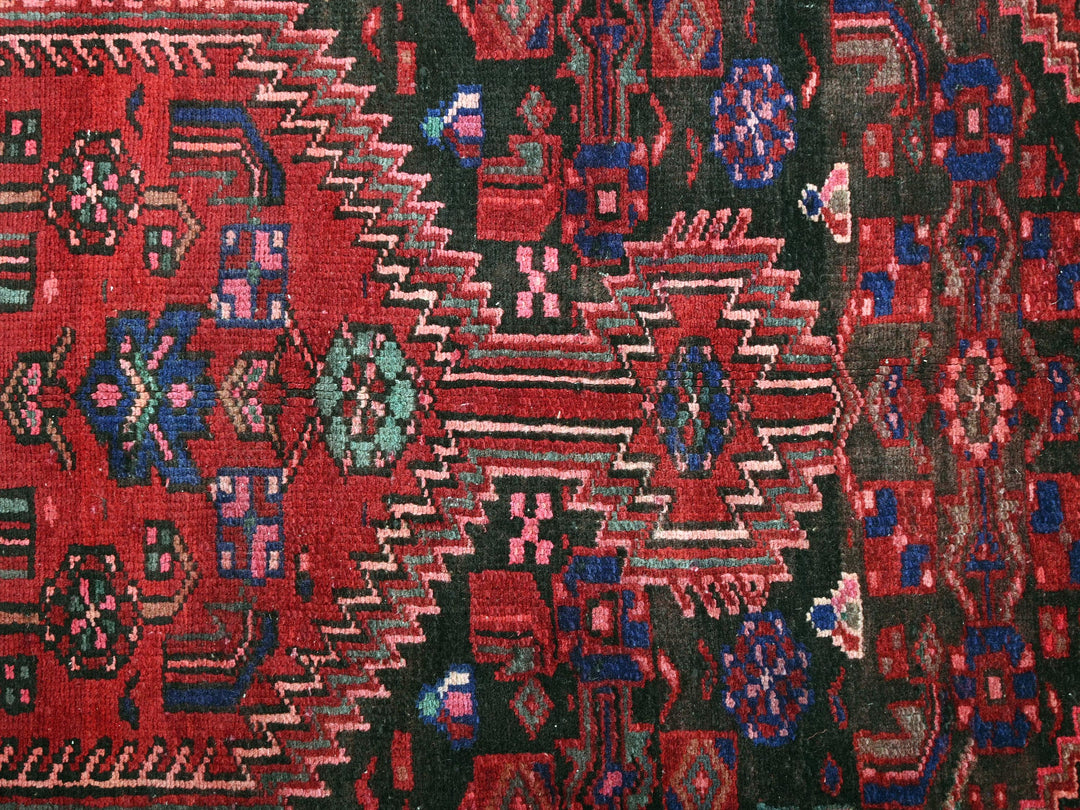 a close up of a red and black rug