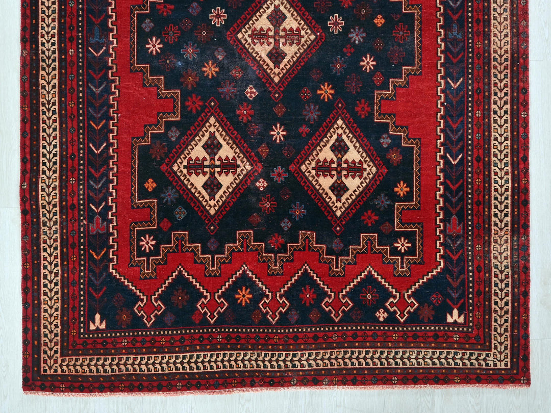 a red and black rug on a white wall