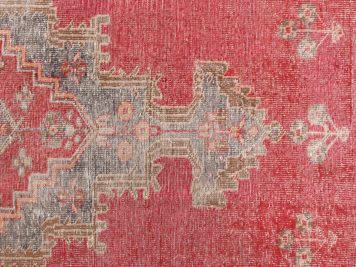 a red area rug with a pattern on it