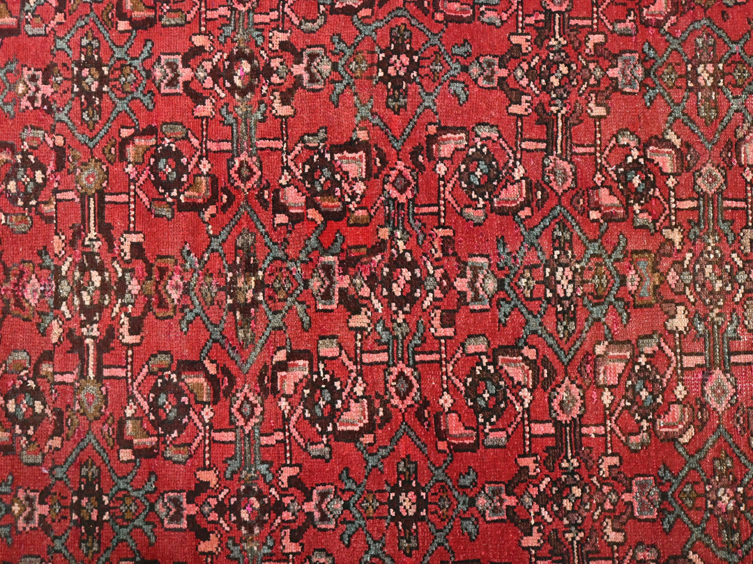 a red rug with a pattern on it