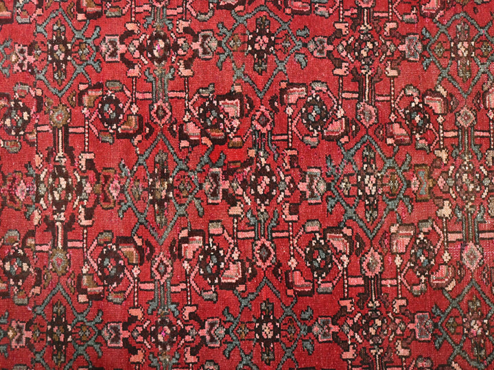 a red rug with a pattern on it