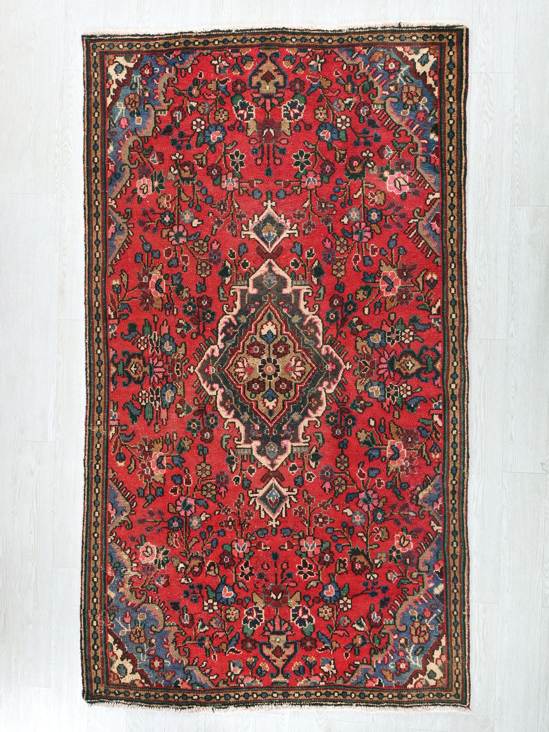 a red rug with a diamond design on it