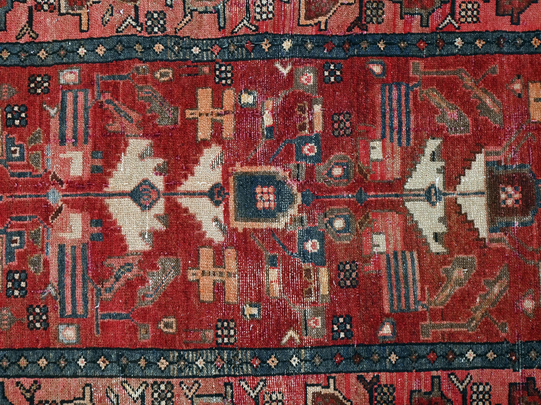 a red rug with many different designs on it