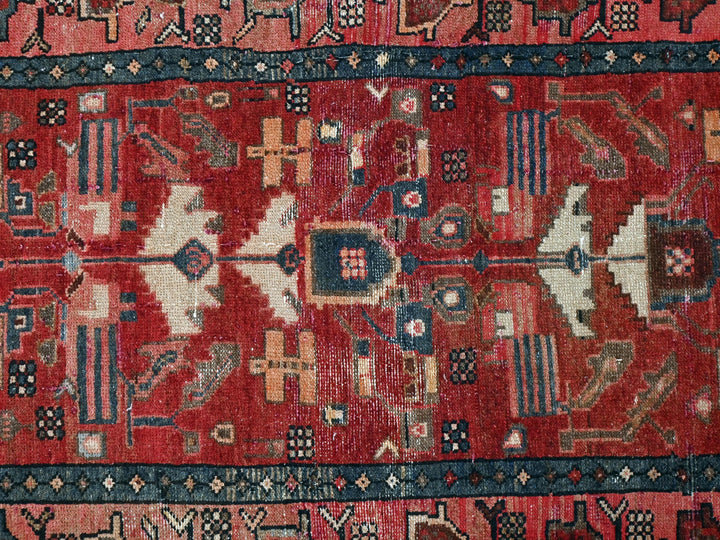 a red rug with many different designs on it