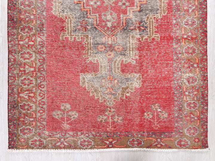 a red rug with an intricate design on it