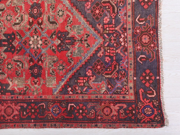 a red and blue rug with a design on it