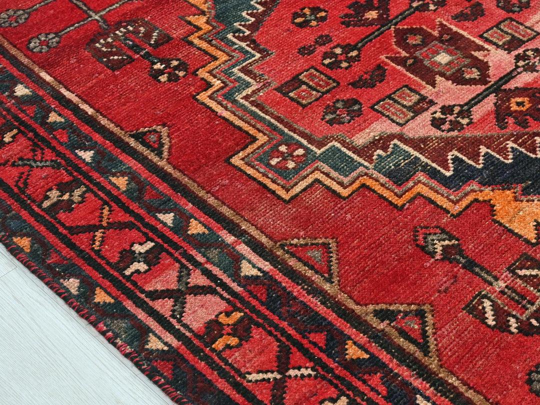a close up of a red oriental rug