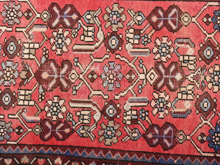 a red rug with a design on it