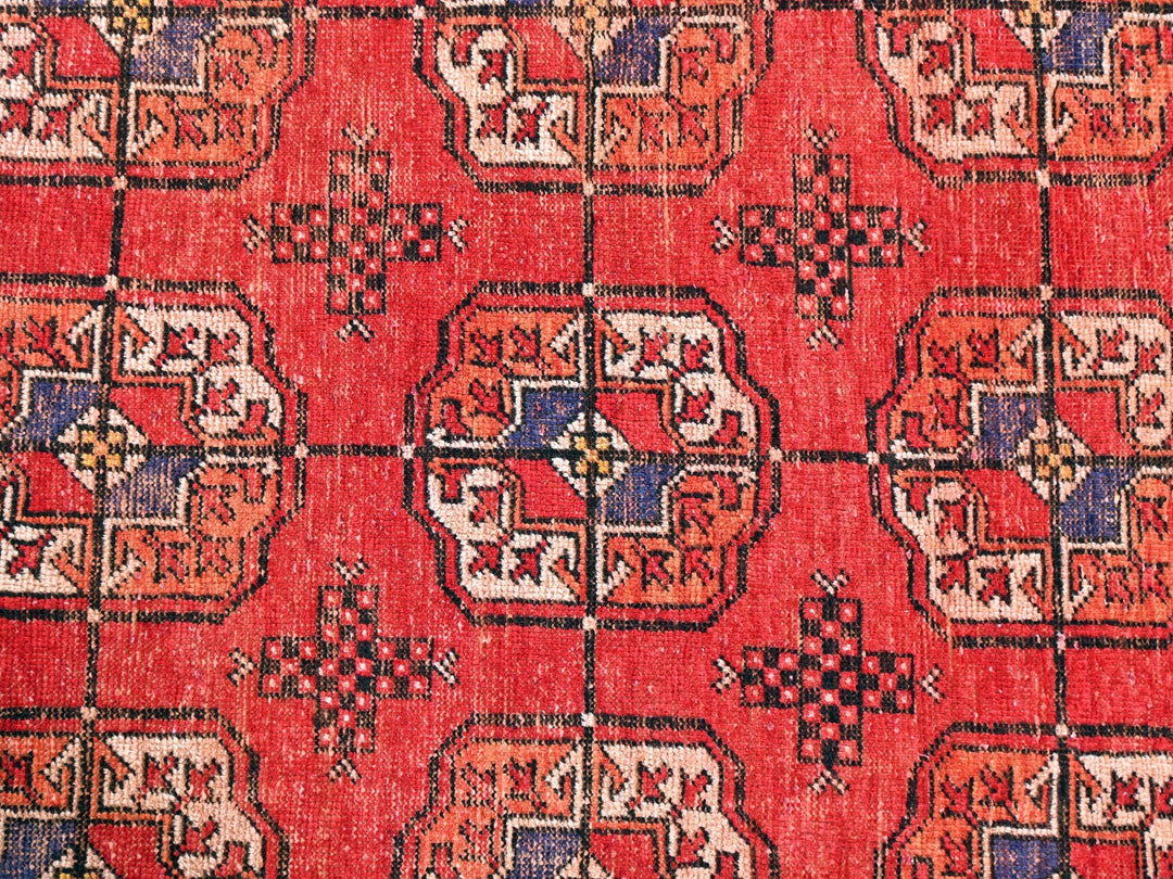 a close up of a red rug with a pattern on it