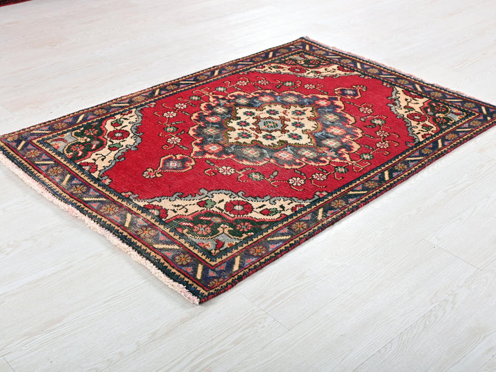 a red rug on the floor of a room