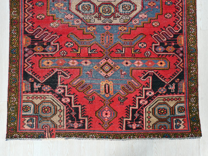 a red rug with an intricate design on it