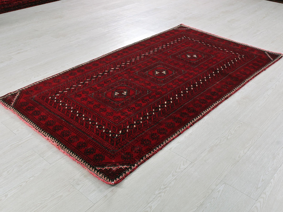 a red rug on the floor of a room