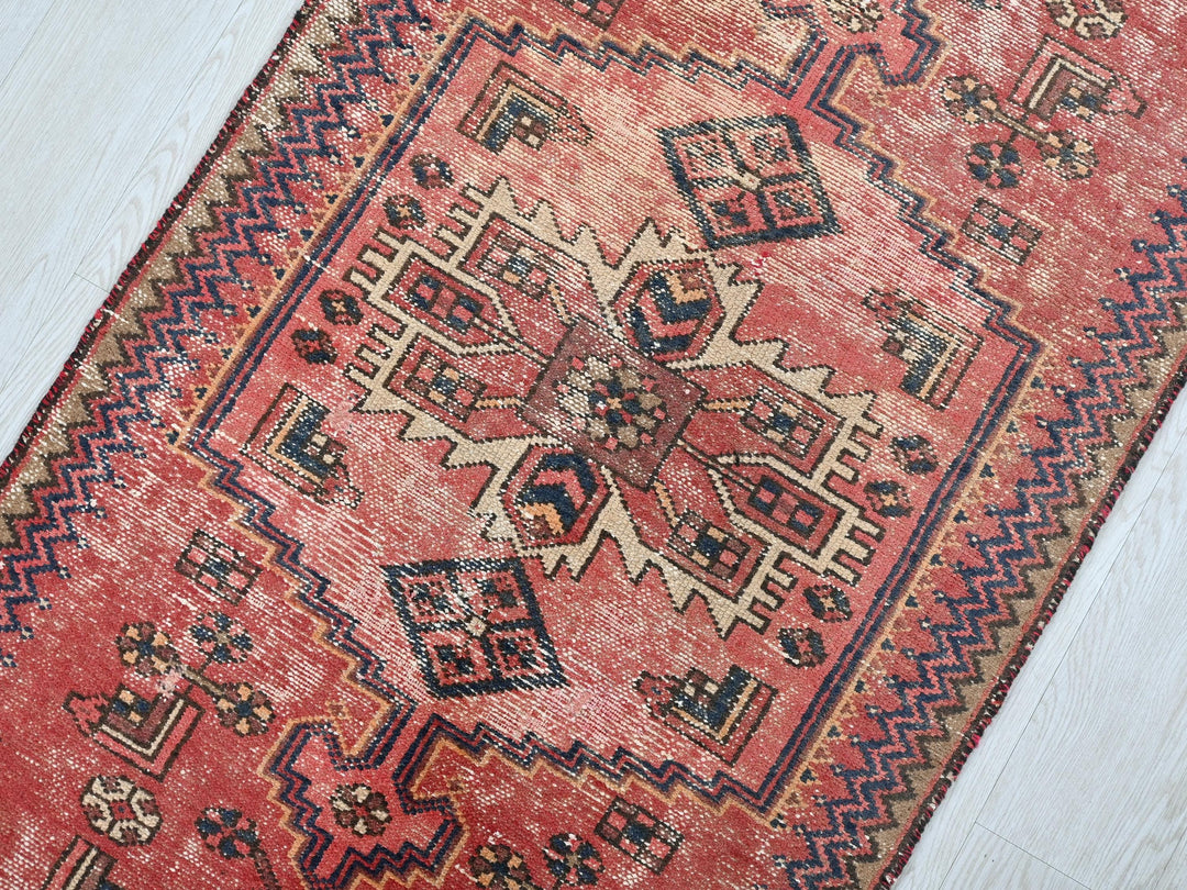 a red rug on a white wooden floor