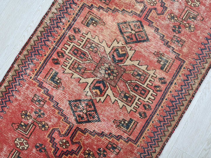 a red rug on a white wooden floor
