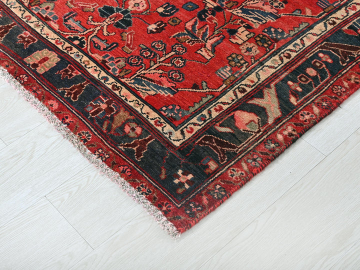 a red oriental rug on a white wooden floor