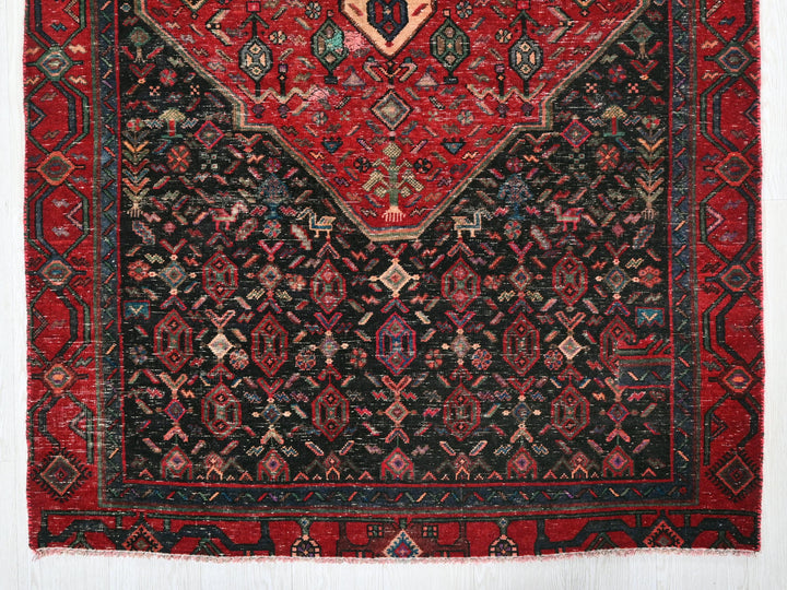 a red and black rug with a design on it